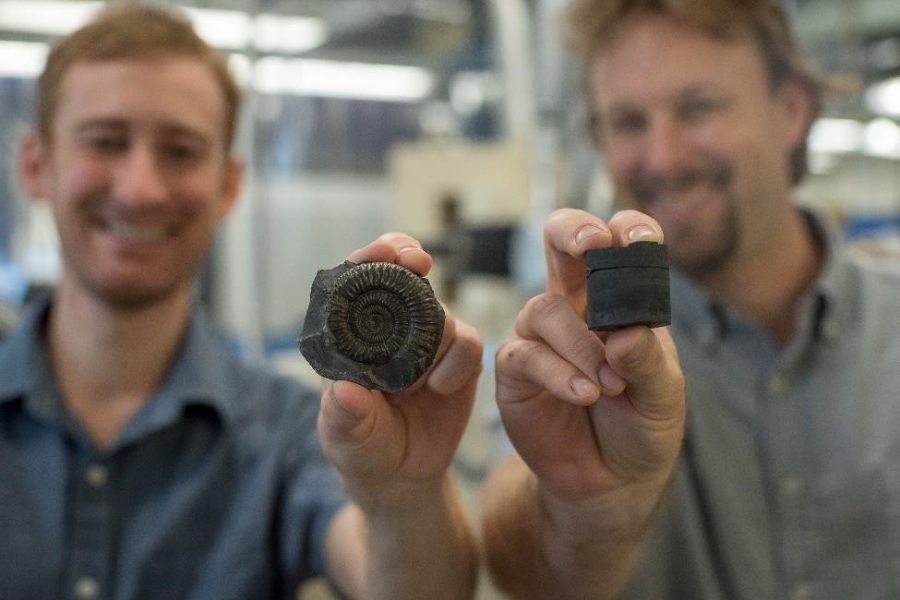 Postdoctoral Researcher Theodore Them (left, holding an extinct fossil sample) and Assistant Professor Jeremy Owens (right, holding a rock core sample). The researchers used the samples to study the global record of oxygenation. Credit: Stephen Bilenky