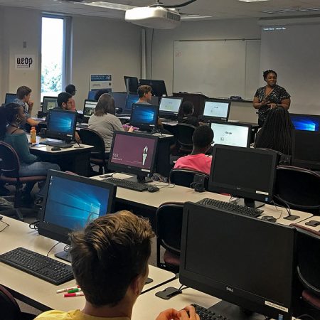 iSchool instructor Christy Chatmon helps high school students from Leon and Gadsden counties learn tech skills at FSU iCamp, hosted in partnership with the U.S. Army Educational Outreach Program. (Photo: College of Communication and Information)