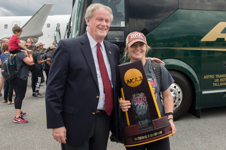 FSU President John Thrasher welcomes home star player Jessie Warren at Tallahassee International Airport on June 6, 2018, following the team's victory at the 2018 Women's College World Series in Oklahoma City. (FSU Photography Services)