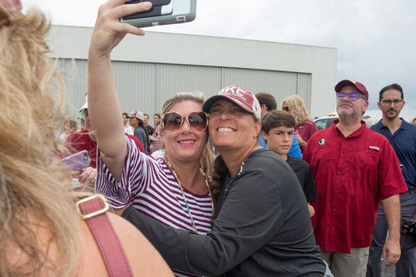 FSU Softball Coach Lonni Alameda takes a selfie with a fan at Tallahassee International Airport on June 6, 2018, after arriving home from the team's victory at the 2018 Women's College World Series in Oklahoma City. (FSU Photography Services)