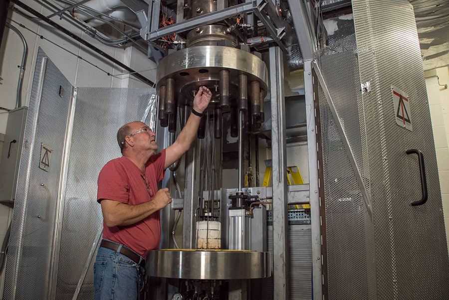 Research Engineer Charles Lamar English works on a specialized furnace used to develop magnet coils from the high-temperature superconductor Bi-2212, a version of bismuth strontium calcium copper oxide. Photo by Stephen Bilenky/National MagLab.