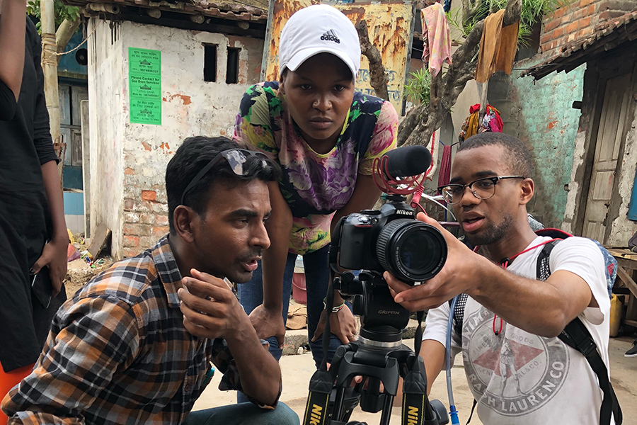 Dwight James III (right) films an anti-smoking advertisement in Dakshindari, India.