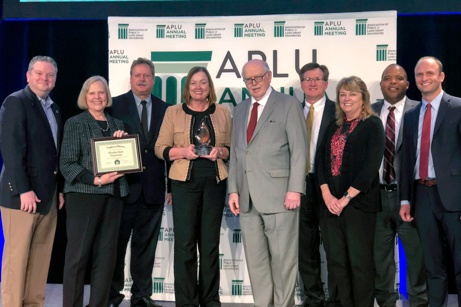 Provost and Executive Vice President for Academic Affairs Sally McRorie, along with a team of FSU leaders, accepts the prestigious national award from APLU President Peter McPherson.