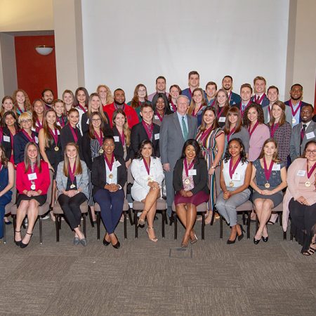 The newest members of FSU's Garnet and Gold Society post with President John Thrasher during an induction ceremony Tuesday, Dec. 4, 2018. (FSU Photography Services)