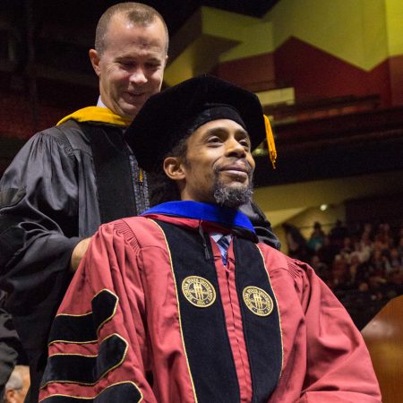 Pablo Correa receives a doctoral hood from Professor Davis Houck, signifying he has completed all requirements for a doctorate in communication — 2018 Fall Commencement. (FSU Photography Services)