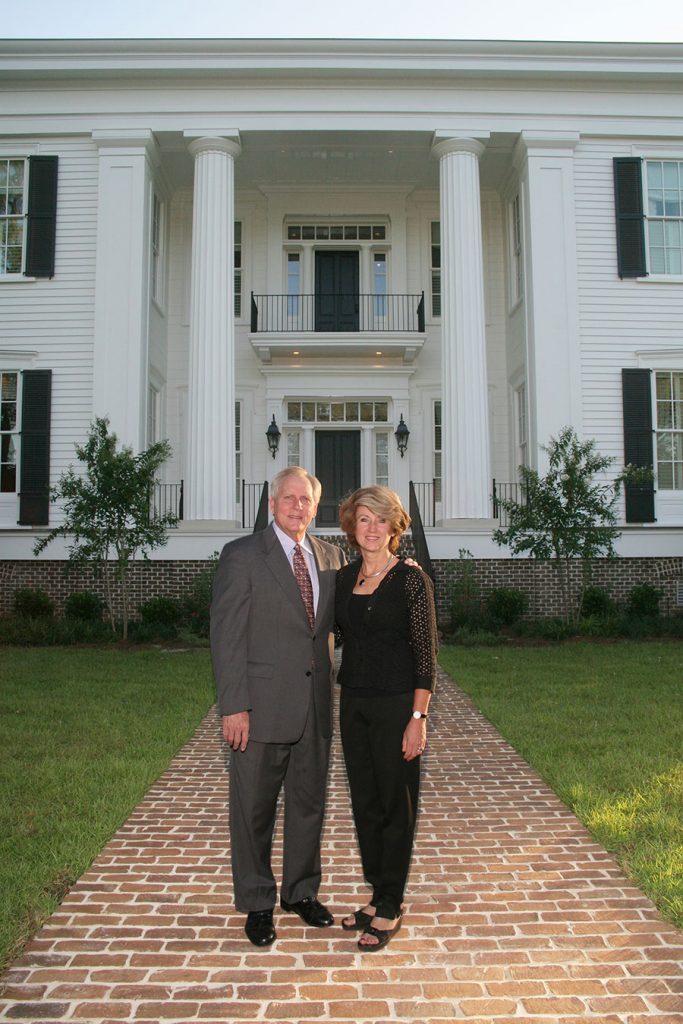 The 13th president of Florida State University, T.K. Wetherell, and his wife, Ginger, pose in front of the President's House on campus.