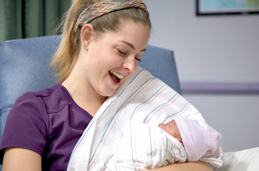 FSU alumna Ciele Gutierrez offers medical music therapy to a baby in the neonatal intensive care unit. "Sometimes when a mom is holding her baby and I’m providing music therapy she will say, 'Wow, I can feel her breathing slowing down and she's just kind of melting into me and becoming more relaxed.' So, the moms themselves are feeling their babies' physical change.” (Photo: Tallahassee Memorial HealthCare)