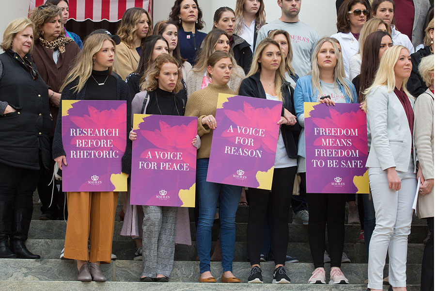 Friends and classmates of Maura Binkley hold signs in support of Maura's Voice. (Bill Lax/FSU Photography Services)