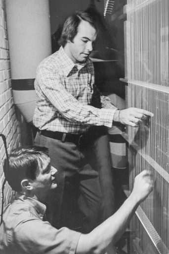 In 1975, FSU's Michael Corzine (standing), at the time an assistant professor of organ, consulted with organ builder Walter Holtkamp Jr. on the design of a new pipe organ for Opperman Music Hall. Here, they check the Holtkamp organ's "trackers," which connect keys and pedals to the pipe's vales. (Photo: Michael Corzine)