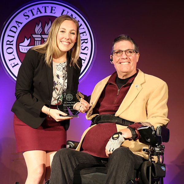 Madison Shaff accepts her first of three awards, the J.R. Harding Award, from J.R. Harding at the Leadership Awards Night April 9, 2019. (Photo: Division of Student Affairs)