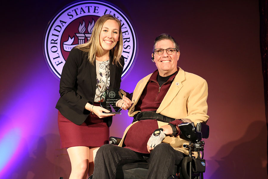 Madison Shaff accepts her first of three awards, the J.R. Harding Award, from J.R. Harding at the Leadership Awards Night April 9, 2019. (Photo: Division of Student Affairs)
