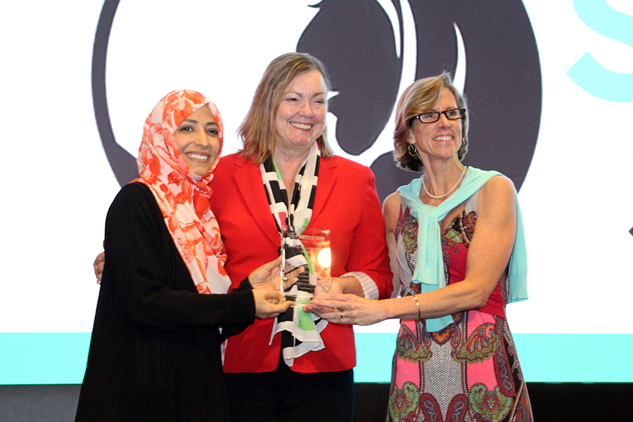 Provost Sally McRorie (middle) accepts the PeaceJam Foundation's inaugural Innovative Leadership Award from Nobel Peace Prize laureate Tawakkol Karman and Kate Cumbo, the executive director of the PeaceJam Foundation.