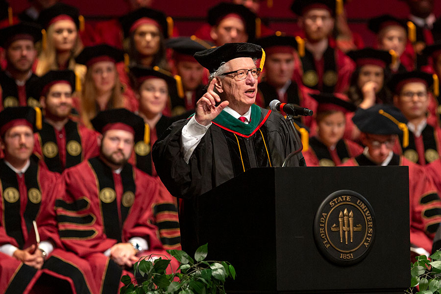 Commencement speaker Michael Muszynski, retiring dean of the Orlando Regional Campus, addresses graduates at FSU College of Medicine commencement May 18, 2019. (FSU Photography Services)