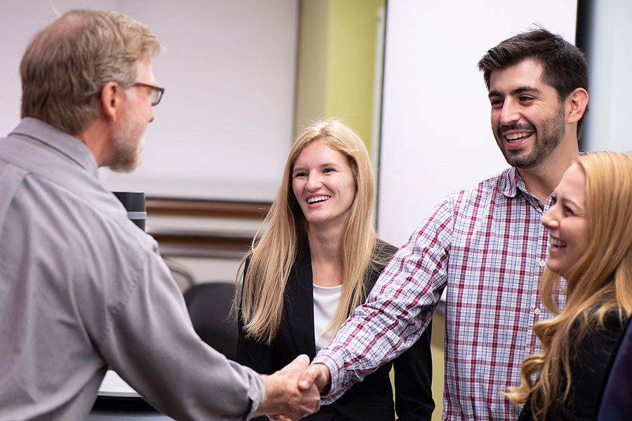 Steve McClellan, from left, principal data scientist at Integrated Musculoskeletal Care, Inc. visits with Master of Science in Business Analytics (MS-BA) students Bryce Shay, Zachary Anders and Kellie Nielson before their final class presentation. Each student team was tasked with exploring IMC data and developing a business project to tackle and present.