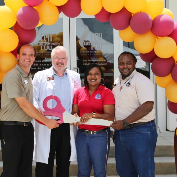 (Left to right) Jason Rybicki, vice president of FSU PrimaryHealth’s community advisory board; Daniel Van Durme, senior associate dean for clinical and community affairs; Anicia Robinson, principal of Sabal Palm Elementary; and Johnnie Seals, a neighborhood resident and job-site superintendent for Childers Construction, cut the ribbon at the College of Medicine's new primary-care health health center, FSU PrimaryHealth.