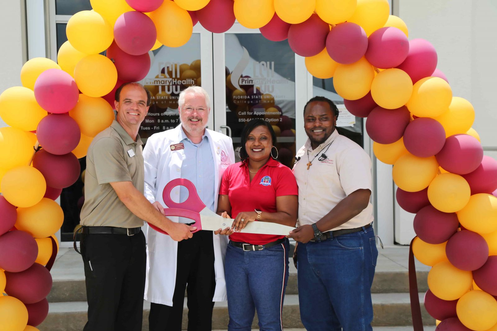 (Left to right) Jason Rybicki, vice president of FSU PrimaryHealth’s community advisory board; Daniel Van Durme, senior associate dean for clinical and community affairs; Anicia Robinson, principal of Sabal Palm Elementary; and Johnnie Seals, a neighborhood resident and job-site superintendent for Childers Construction, cut the ribbon at the College of Medicine's new primary-care health health center, FSU PrimaryHealth.