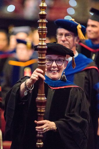 Professor Susan Fiorito, director of the Jim Moran School of Entrepreneurship, leads the procession at the 2018 summer commencement. (FSU Photography Services)