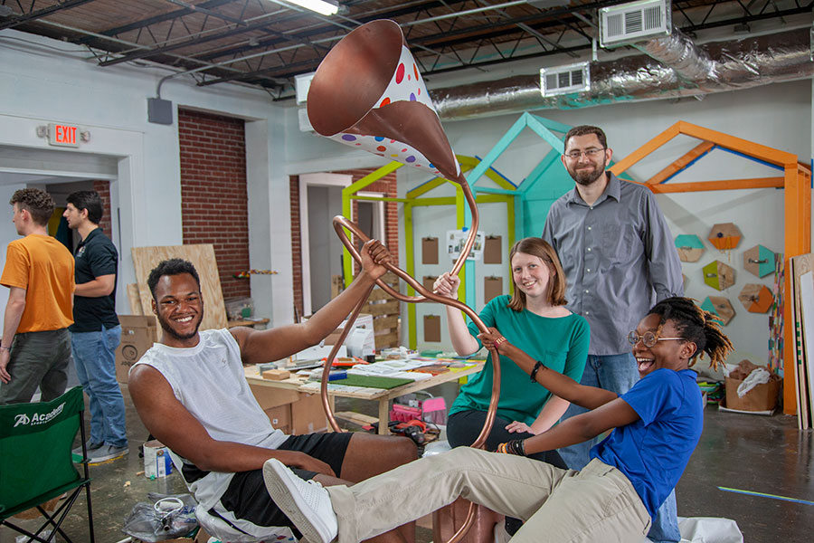 From left to right: Owen Paul, Maddie Wishart, Associate Professor Jonathan Clark and Brianna Wylie show off their mechatronic installation. (Patricia Radulovich).