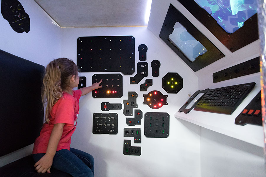 A child testing out the mechatronic spaceship built by students in the Mechatronic Art class at FSU. (Anna Prentiss).