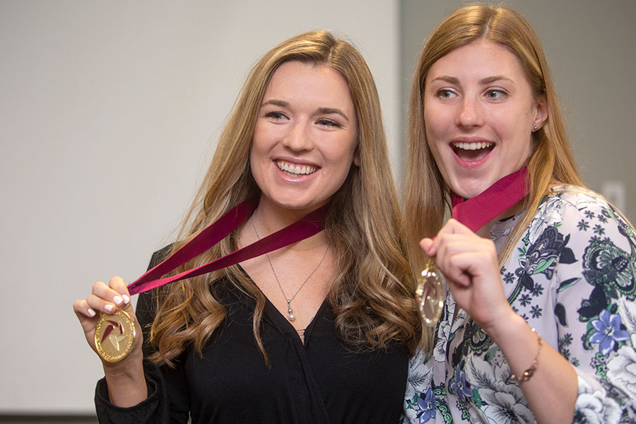 Students Ashley Falzoi (L) and Linnea Blackmore (R) pose with their medals at the Summer 2019 Garnet & Gold Scholars induction ceremony. (FSU Photography Services)