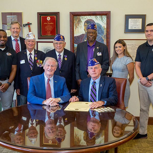 Seated, from left: FSU President John Thrasher and Rick Stanford, commander of the Tallahassee chapter of the Military Order of the Purple Heart. Standing, from left: Sean Williams, director of the FSU Veterans Student Union; Billy Francis, director of the Student Veterans Center; MOH chapter members Ken Swords, Mike Ford and Ned Hill; VSU assistant director Aaliyah Abarzua; and Matt Caraway, treasurer of the FSU Collegiate Veterans Association.