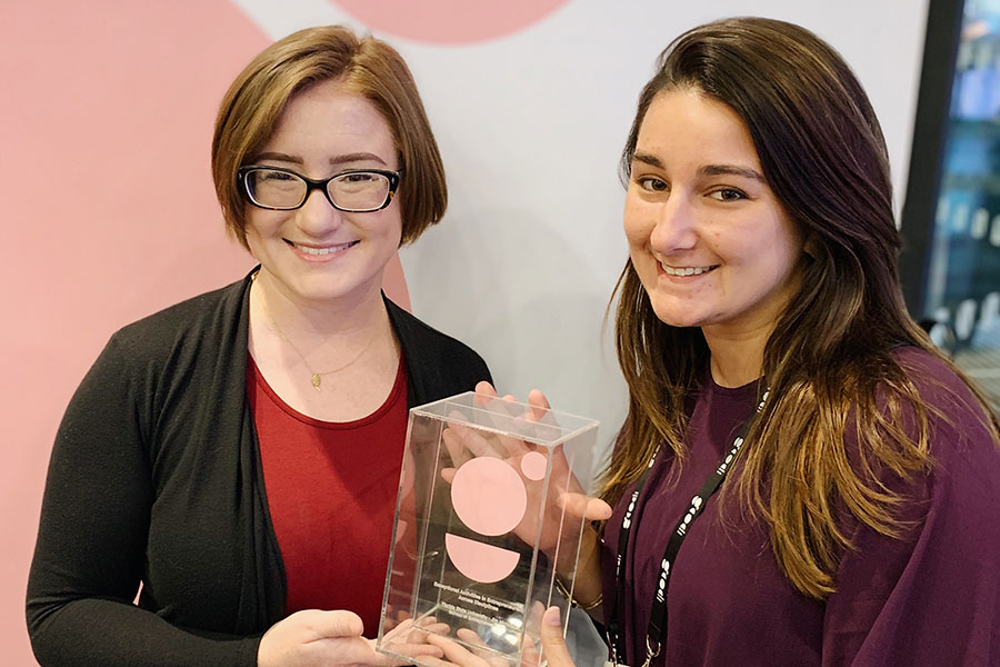 Jim Moran School of Entrepreneurship staff members Kaitlin Simpson and Kirsten Frandsden with the Global Consortium of Entrepreneurship award, which they picked up last month in Stockholm, Sweden.