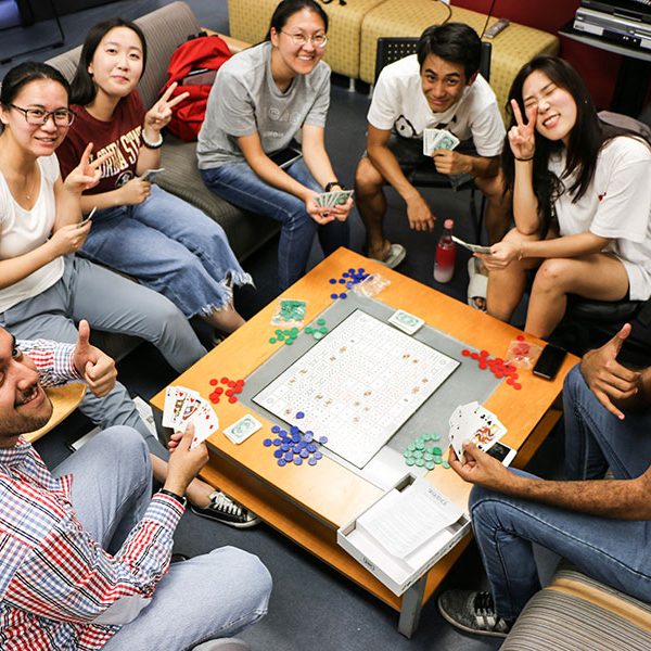 Students play cards in the student lounge at FSU's Center for Intensive English Studies.