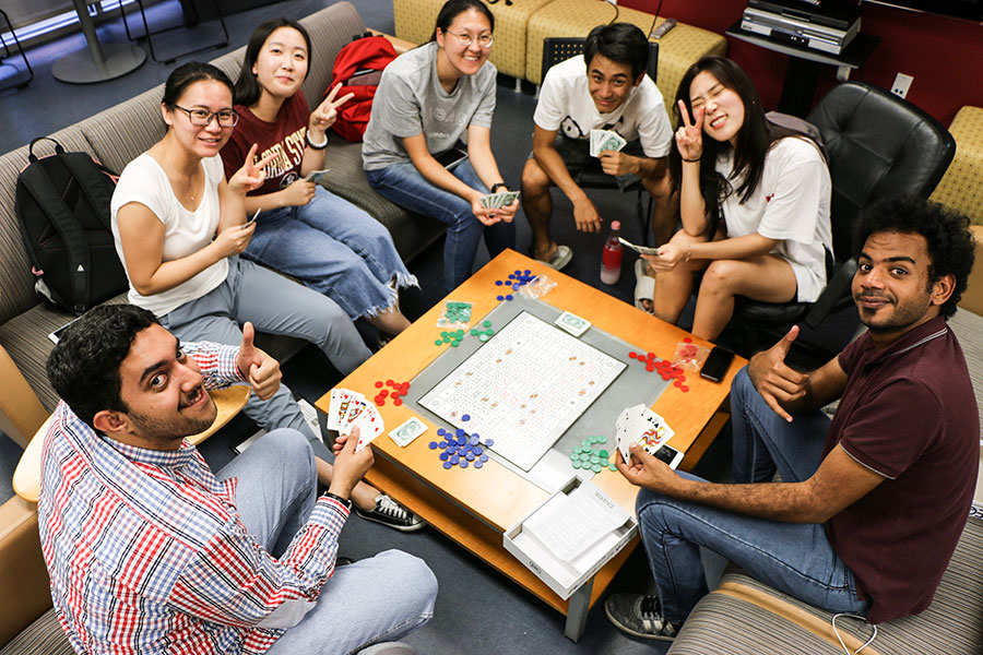 Students play cards in the student lounge at FSU's Center for Intensive English Studies.