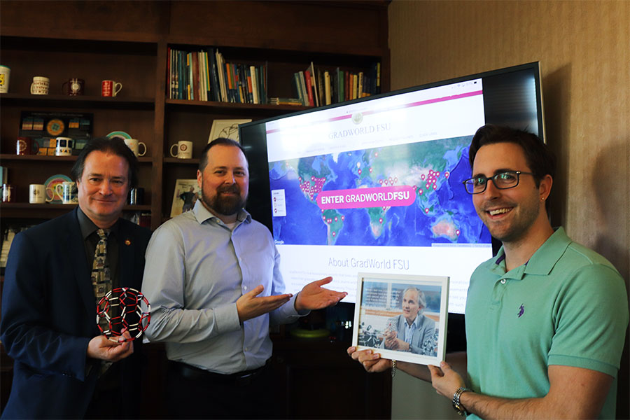 Mark Riley, dean of The Graduate School; Rodney Johnson, assistant director of Creative Services for Web; and James Beck, The Graduate School, show off the new GradWorld FSU.