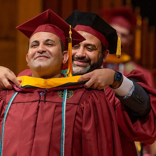 Tamer Tadros being hooded by his brother, Basim Tadros, who is a physician with Southern Medical Group in Tallahassee, as the first graduates of the FSU School of Physician Assistant Practice celebrate commencement Saturday, Dec. 14. (FSU Photography Services)