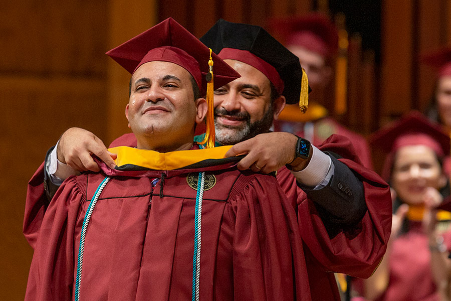 Tamer Tadros being hooded by his brother, Basim Tadros, who is a physician with Southern Medical Group in Tallahassee, as the first graduates of the FSU School of Physician Assistant Practice celebrate commencement Saturday, Dec. 14. (FSU Photography Services)