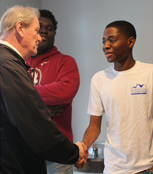 President Thrasher greets SSF students at the new house Saturday, Jan. 11.