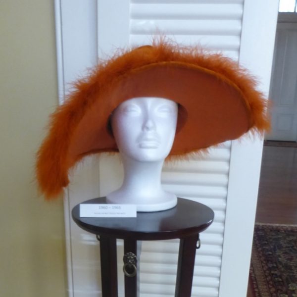 “Orange!” Schofield said of this “slouch” hat, which dates to the 1960s. “It’s kind of wrinkled, kind of slouchy. It’s got some feathers on it. But in thinking about the 1960s, you’ve got long, straight hair. It’s not dissimilar from the 1920s with no-volume hair.”