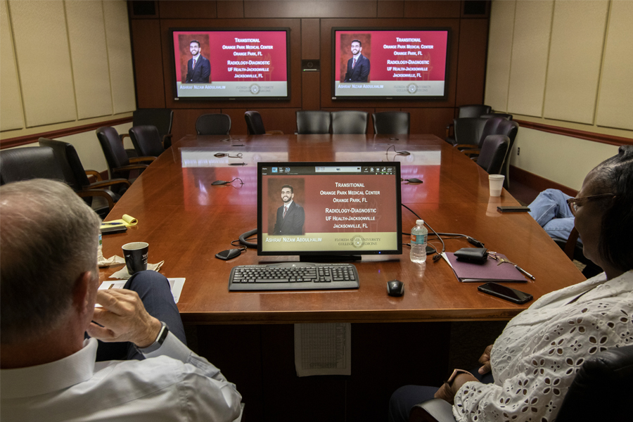 Dr. John P. Fogarty, dean of the College of Medicine, and Dr. Alma Littles, senior associate dean for Medical Education and Academic Affairs, watch the college's Match Day Ceremony online. Due to concerns about the global COVID-19 pandemic, the medical school replaced its annual on-campus ceremony with a virtual event. Photo by: Bruce Palmer / FSU Photography Services