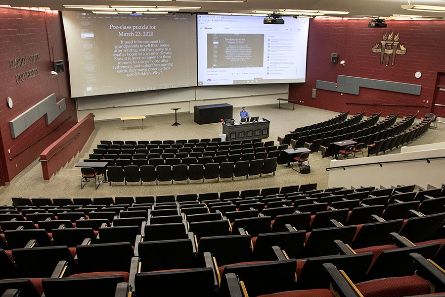 Michael Hammock, an assistant teaching professor of economics, taught his class via YouTube in the vacant lecture hall that holds 500 students. (FSU Photography Services/Bruce Palmer)