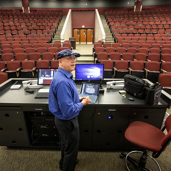 Michael Hammock, an assistant teaching professor of economics, taught his class via YouTube in the vacant lecture hall that holds 500 students. (FSU Photography Services/Bruce Palmer)