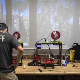 Ren Saludo, assistant director of Design and New Technologies at the Innovation Hub, checks on the 3D printers. (FSU Photography Services)