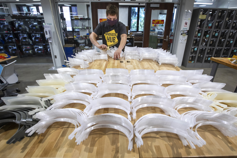 Richard Ensor, sculpture lab manager with the FSU Department of Art, performs finishing refinements on the face shield brackets after they are printed at the Innovation Hub. (FSU Photography Services)