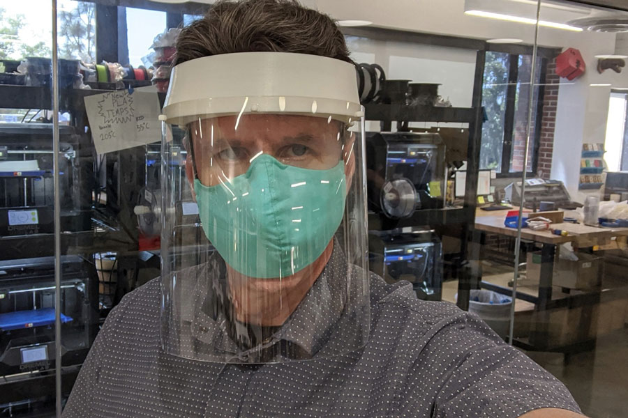 Ken Baldauf, Founding Director of the Innovation Hub, wearing one of the hundreds of face shields that the facility has produced.