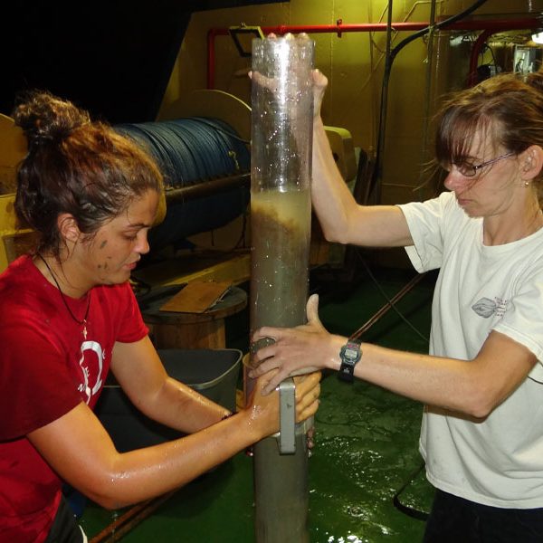 Rachel Kalin, left, an alumna of Eckerd College, and FSU research assistant Samantha Bosman transferring a core sample during a research cruise. (Photo: Devon Firesinger)