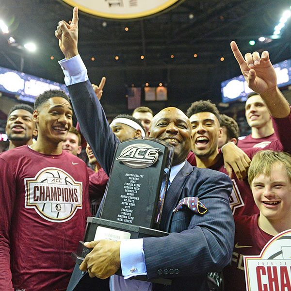 FSU men's basketball head coach Leonard Hamilton celebrates the 2019-2020 ACC Championship with his team.