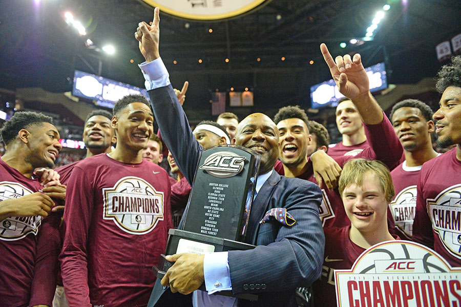 FSU men's basketball head coach Leonard Hamilton celebrates the 2019-2020 ACC Championship with his team.