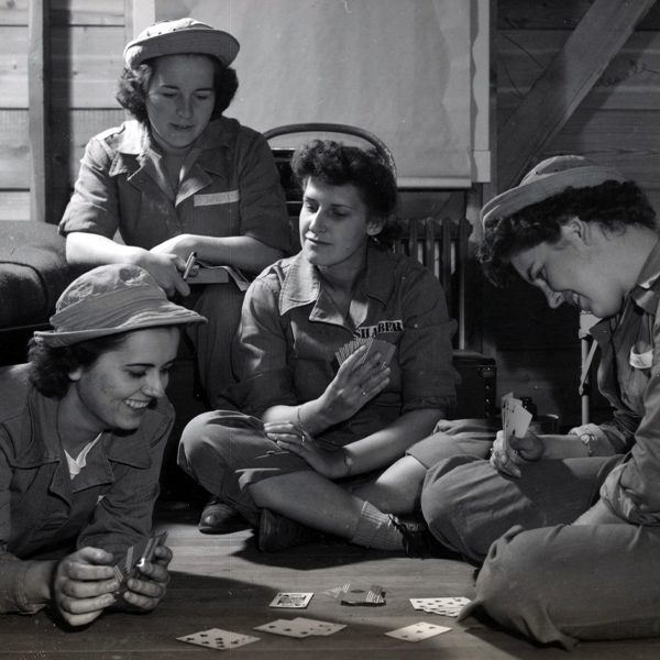 Soldiers playing cards in a photo from Charlotte Mansfield's World War II scrapbooks. Courtesy of the Institute on World War II and the Human Experience.