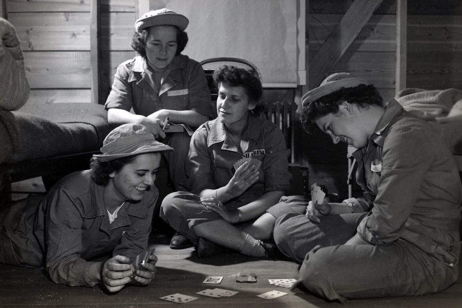 Soldiers playing cards in a photo from Charlotte Mansfield's World War II scrapbooks. Courtesy of the Institute on World War II and the Human Experience.