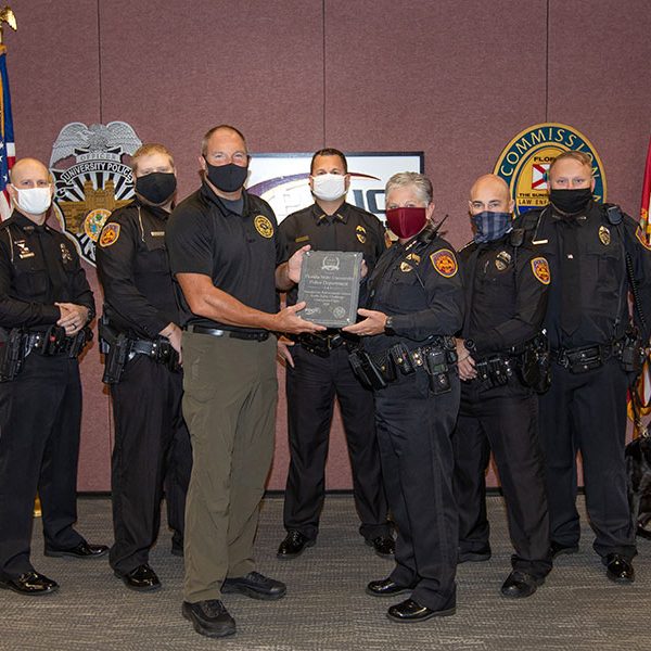 FSUPD accepts first-place in the Champions Category of the 2020 Florida Law Enforcement Challenge Awards. From left: Officer Chase Yarborough, Officer Dan Cutchins, Law Enforcement Liaison Andy Johnson, Lt. John Baker, Chief Terri Brown, Officer Steve Black, Officer Adam Walker and K9 Tomahawk. (FSU Photography Services)