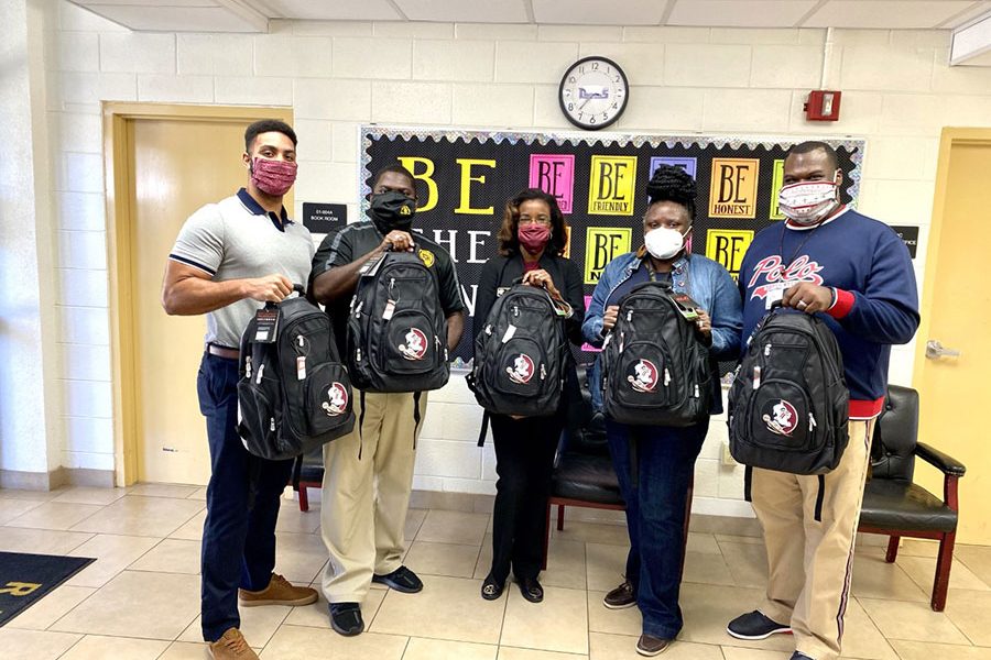 As part of FSU CARE's Back to School Drive, CARE staff dropped off backpacks and school supplies at R. Frank Nims Middle School in Leon County. The funding that CARE recently received will continue to support efforts like this. From left to right: CARE Program Assistant TJ Callan, Nims Principal Dr. Benny Bolden, CARE Assistant Director Inika Williams, Law Magnet Coordinator Altovise Mitchell, and Nims Assistant Principal Tyneal Haywood Sr. (CARE/Inika Williams)