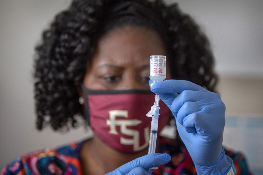 Latricia Simmons, RN, assistant director of Clinical Operations at University Health Services draws up a dose of the COVID-19 vaccine. (FSU Photography Services)