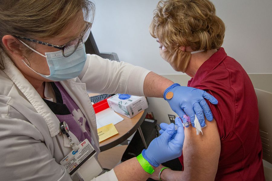Patricia Prince, ARNP-BC receives a COVID-19 vaccine from Colleen Putnam, RN supervisor at University Health Services. (FSU Photography Services)