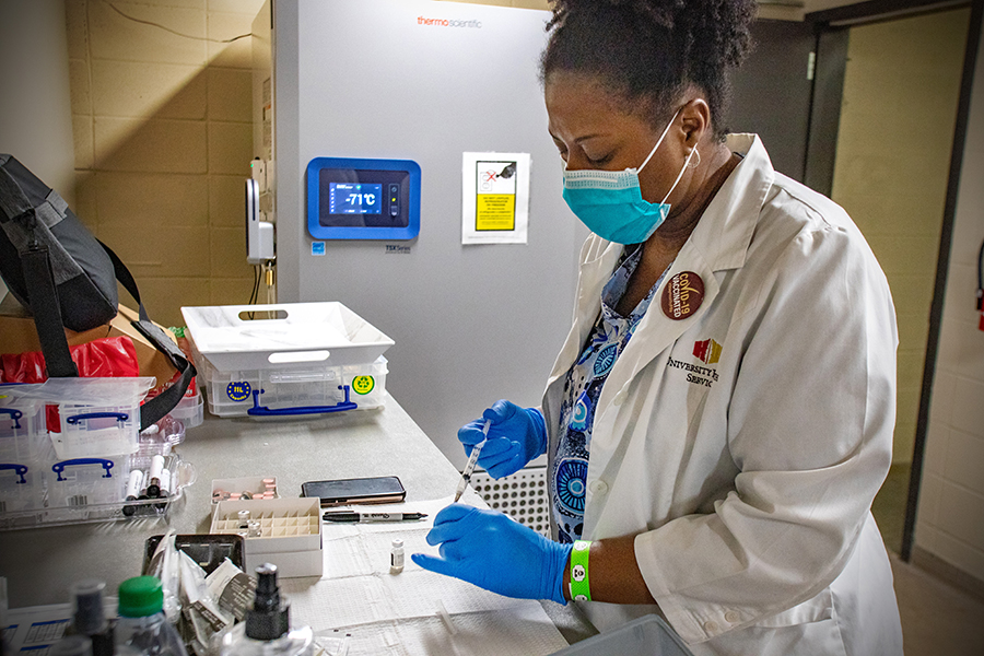 A registered nurse from FSU University Health Services prepare COVID-19 vaccines for patients at the Donald L. Tucker Civic Center. (FSU Photography Services / Bil Lax)