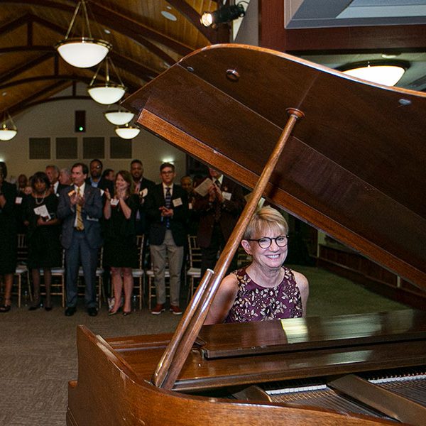 Mrs. Cottrell plays "Hymn of the Garnet and Gold" on the piano at an FSU event.